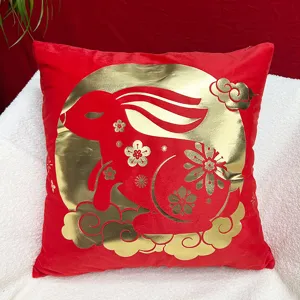 Detailed close-up of the festive red and gold Chinese New Year rabbit plush throw pillow cover.