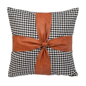 Black and white houndstooth velvet throw pillow with brown leather bow, sofa cushion.