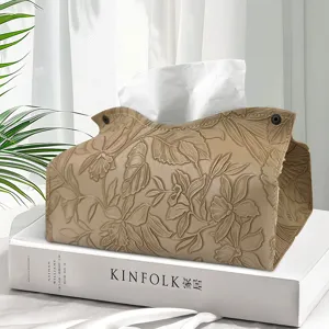 Modern leather tissue box with embossed floral design, elegant decorative napkin holder for living room.