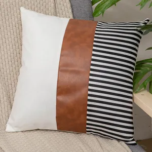 Modern leather patchwork pillow cover featuring white, brown faux leather and stripes.