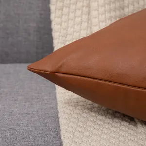 Close-up detail of premium brown leather pillowcase showing fine stitching texture and cozy design.