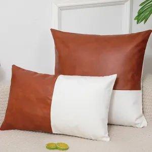 Detailed view of colorblocked leather and fabric throw pillow covers in a cozy home setting.