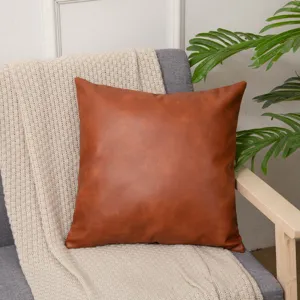 Brown leather throw pillow detail, stylish square cushion cover for home sofa decor and comfort.