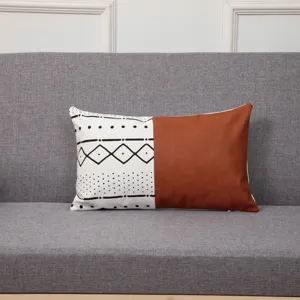 Detailed view of geometric patchwork throw pillow cover with brown leather and ethnic pattern.