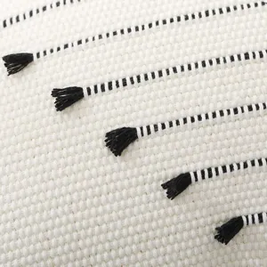 Cotton bohemian woven throw pillow close-up texture detail showcasing minimalist black striped tassels.