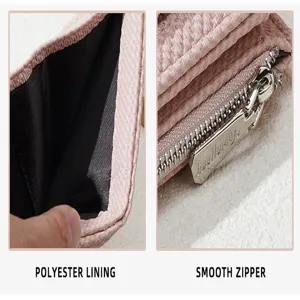 Detailed close-up of women's pink short wallet showing polyester lining and smooth metal zipper.
