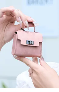 Mini rosa Leder Tasche Anhänger Detailansicht, süßer Schlüsselanhänger mit Metallschloss.