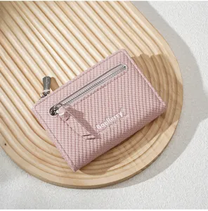Elegant pink short women wallet with zipper pocket, stylish textured faux leather coin purse.