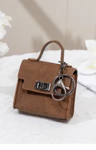 Detailaufnahme des mini braunen Leder-Taschenanhängers, schicken Schlüsselrings & Münzfachs.