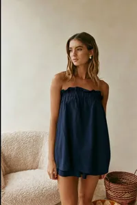 Detailed view of a dark blue cotton linen strapless top and shorts set, summer resort style.