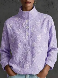 Close-up detail of a lavender stand collar half-placket floral embroidered long sleeve top.