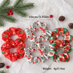 Detailed close-up of Christmas hair scrunchies with festive holiday prints and satin fabric.
