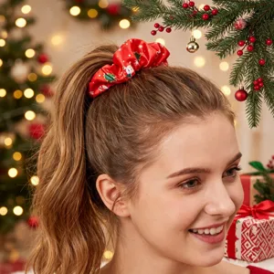 Red satin Christmas hair scrunchie close-up view, festive holiday hair accessory detail.