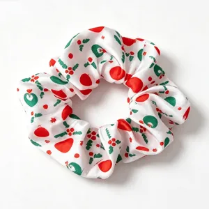 Christmas printed satin hair scrunchie, white fabric hair tie with red and green holiday motifs.