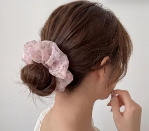 Sheer pink floral chiffon hair scrunchie close-up view, sweet daily ponytail holder.