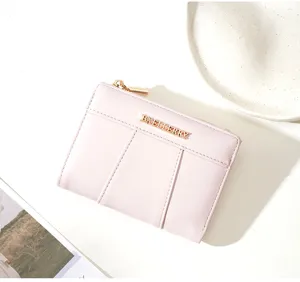 Minimalist pink PU leather short wallet for women with card slots and zip pocket.