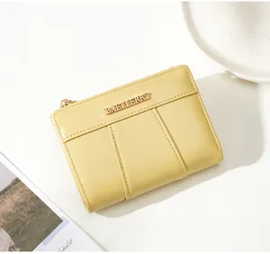 Close-up detail of the minimalist yellow PU leather short wallet featuring multi-card slots.