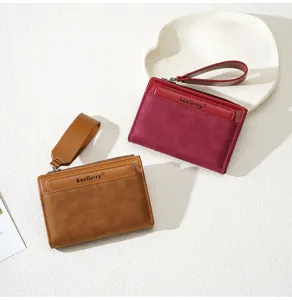 Detail view of women's contrast color short wallet with zipper, card slots and wrist strap.