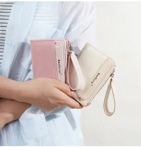 Close-up detail of women's short colorblock wallet with multiple card slots and zipper pocket.