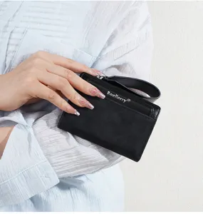 Close-up of a stylish women's short colorblock wallet with wrist strap and zipper.