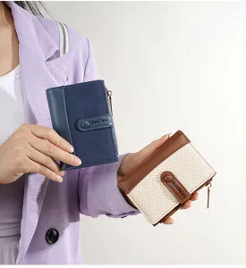 Detail shot of women's short colorblock wallet with snap closure and multi-card slots.
