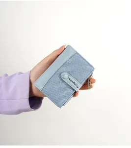 Close-up detail of the short color-contrast women wallet with snap closure and zipper pocket.