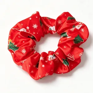 Red Christmas scrunchie with festive snowflake and tree print for holiday hair styling.