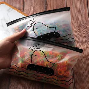 Close-up of colorful disposable hair rubber bands in frosted zipper bags with cute duck print.