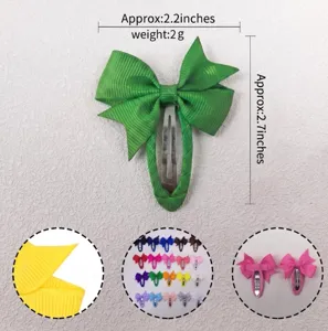 Detailed view of the cute children's green grosgrain ribbon hair clip, showing size and colors.