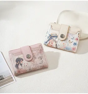 Close-up detail of women's short wallet with cute cartoon girl print and multi card slots.