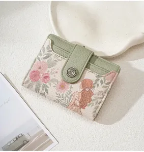 Floral print short women wallet with card slots and cute girl illustration design detail.