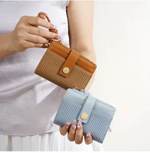 Close-up detail of women short woven wallet with PU leather strap and secure metal snap closure.
