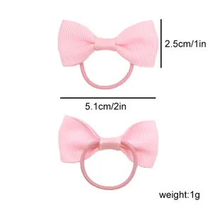 Close-up detail showing size and weight of pink grosgrain ribbon bow hair tie elastic.