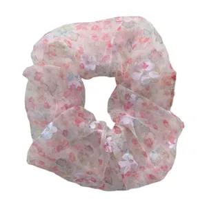 Close-up detail of the pink floral sheer scrunchie, lightweight soft fabric hair accessory.