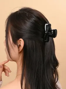 Minimalist black bow hair claw clip for women, stylish PC hair styling accessory for daily use.