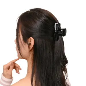 Elegant black bow hair claw clip for women, durable PC material shark clip for chic hairstyles.