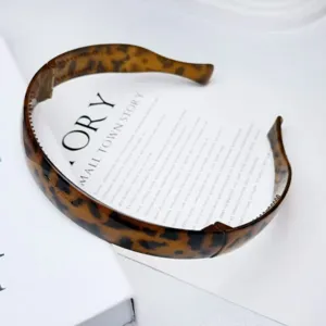 Detail view of the foldable tortoise shell headband, showing stylish pattern and texture.