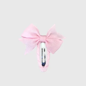 Close-up detail of a sweet pink ribbon bow hair clip featuring a fully wrapped snap design.