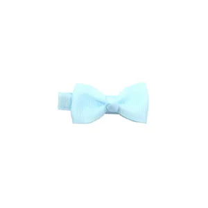 Light blue bow hair clip detail shot, showing the delicate ribbed fabric texture and neat bow knot.