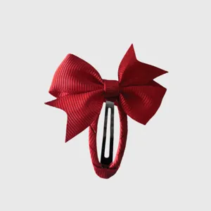 Red ribbon bow hair clip detail view, featuring sweet pastoral style and full wrapped design.