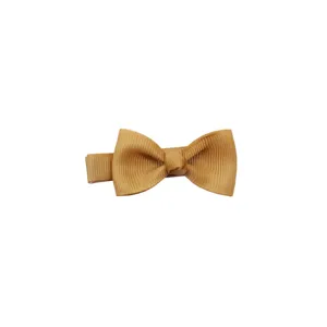 Close-up detail of a solid khaki grosgrain ribbon hair bow clip for cute little baby girls.