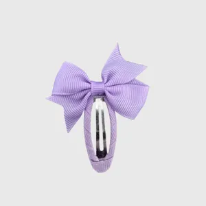 Purple bow hair clip detail view, cute ribbon wrapped hairpin for sweet girls and kids styling.