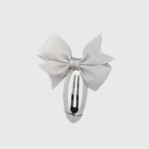 Gray bow hair clip detail shot, showing the exquisite full-wrapped ribbon texture and metal clip.
