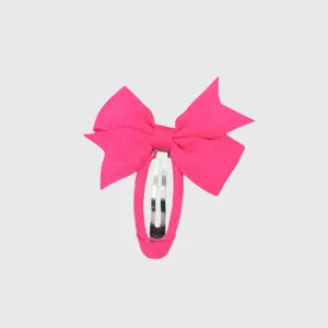 Close-up detail of the bright pink fully wrapped ribbon bow snap hair clip for girls.