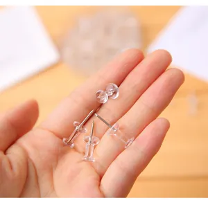 Clear plastic pushpins thumbtacks with sharp metal points for cork boards and office note boards.