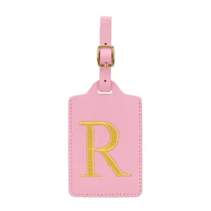 Etichetta bagaglio in pelle PU rosa con lettera R ricamata dorata per valigie da viaggio.