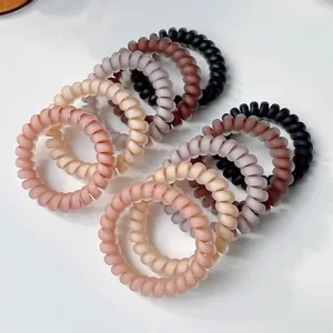 Matte spiral hair ties detail view, colorful plastic telephone wire hair ropes for women styling.