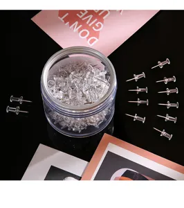 Clear plastic pushpins in a round storage box, ideal for cork boards and office note displays.