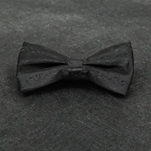Close-up of black jacquard bow tie detail, elegant fabric texture for men formal wear suit accessory