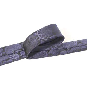 Close up detail of mens navy blue paisley jacquard necktie showing textured fabric weave.